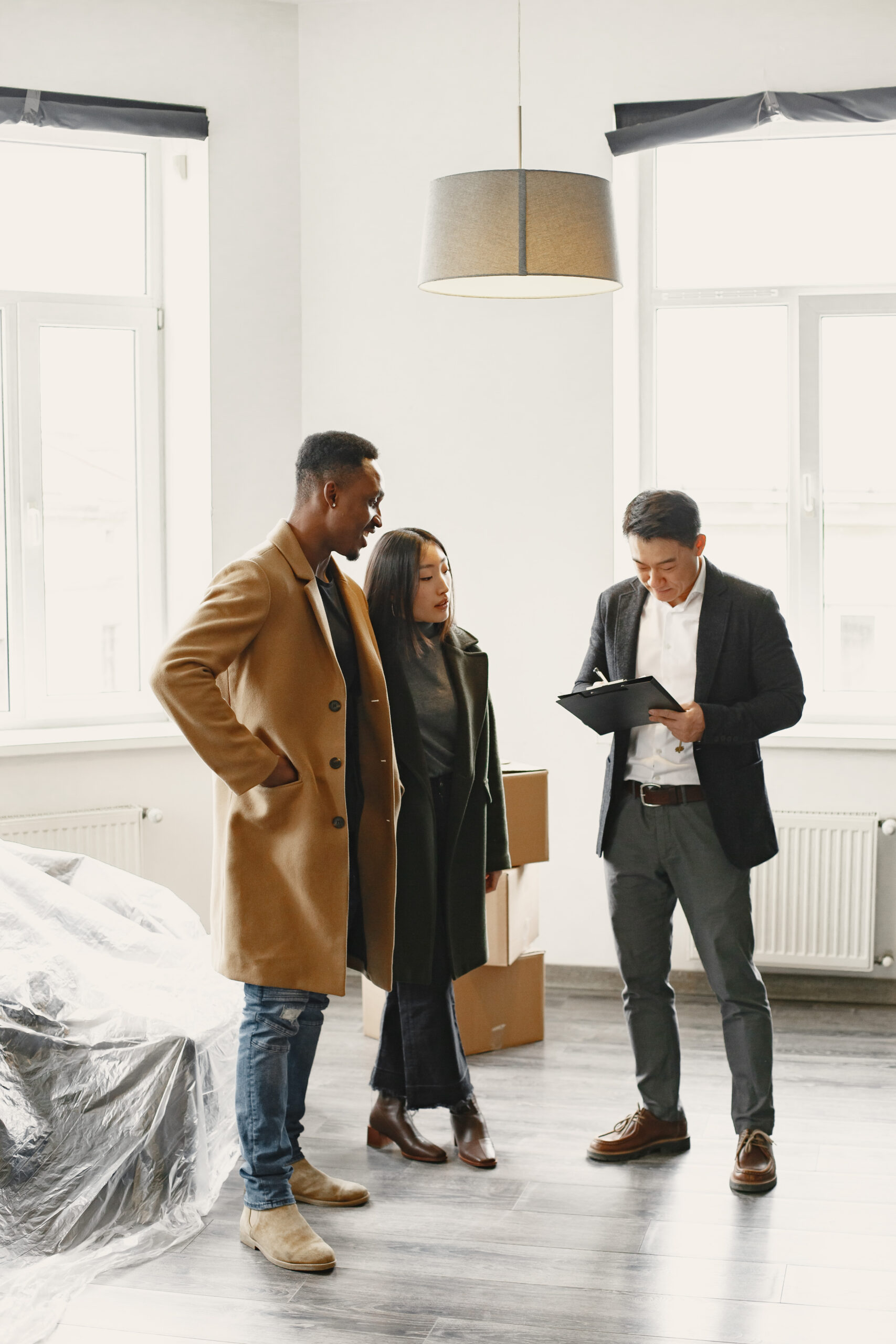 Realtor Explaining Agreement To Couple In New Apartment